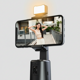 Smartphone with a mounted face tracking camera phone stand and light on a white background