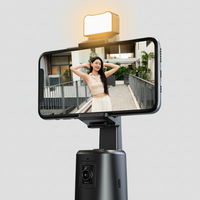 Smartphone with a mounted face tracking camera phone stand and light on a white background