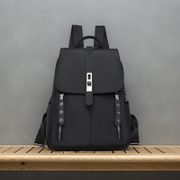 Black anti-theft buckle backpack  on a wooden surface with a gray background