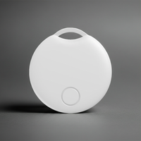 A white apple compatible GPS tracking device for locating items, bags, phones on a gray background