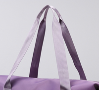 closeup of the handle of the expandable tote bag with removable wheels 