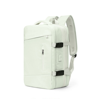 Expandable travel backpack in light mint green, water-resistant with multiple compartments, cute feminine style, TSA zipper access, laptop pocket, shoe and wet item sections, and USB charging port. 