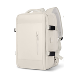 Extendable travel backpack in beige, water-resistant with multiple compartments, TSA zipper access, laptop pocket, shoe and wet item sections, and USB charging port. 