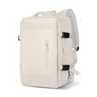 Extendable travel backpack in beige, water-resistant with multiple compartments, TSA zipper access, laptop pocket, shoe and wet item sections, and USB charging port. 