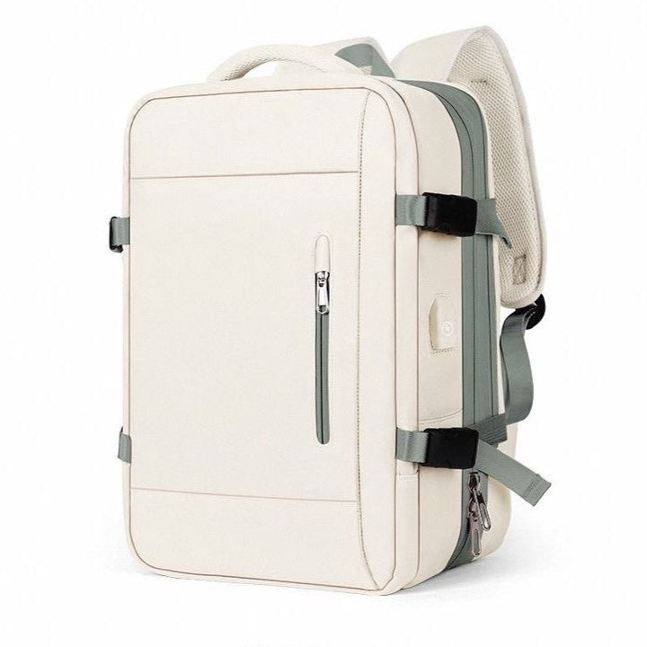 Extendable travel backpack in beige with green details, water-resistant with multiple compartments, TSA zipper access, laptop pocket, shoe and wet item sections, and USB charging port.