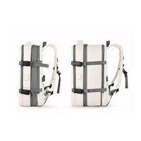 Extendable travel backpack in beige with green details, water-resistant with multiple compartments, TSA zipper access, laptop pocket, shoe and wet item sections, and USB charging port. Side view of expansion.