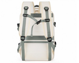 Extendable travel backpack in beige with green details, water-resistant with multiple compartments, TSA zipper access, laptop pocket, shoe and wet item sections, and USB charging port. Back view.