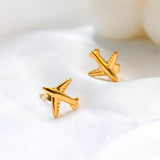 Gold airplane stud earrings made of titanium steel, hypoallergenic and lightweight, travel-inspired minimalist design for women.
