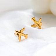 Gold airplane stud earrings made of titanium steel, hypoallergenic and lightweight, travel-inspired minimalist design for women.