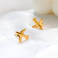Gold airplane stud earrings made of titanium steel, hypoallergenic and lightweight, travel-inspired minimalist design for women.