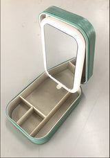 A LED makeup mirror with storage compartments, displayed in a green color, partially opened to show the mirror and storage space.
