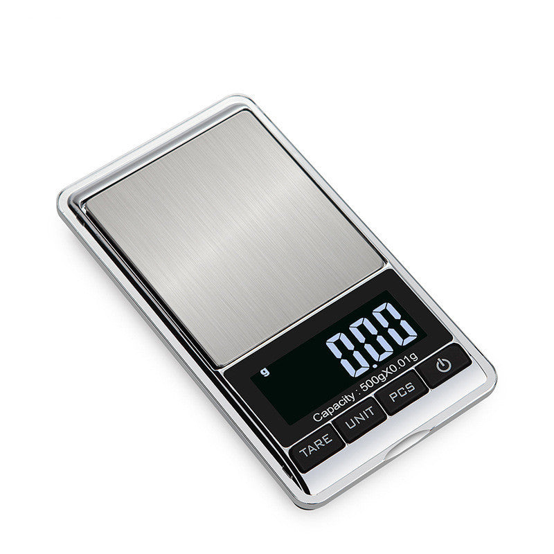 A compact and sleek Mini Pocket Electronic Scale with a stainless steel surface and a digital LCD display showing the weight.