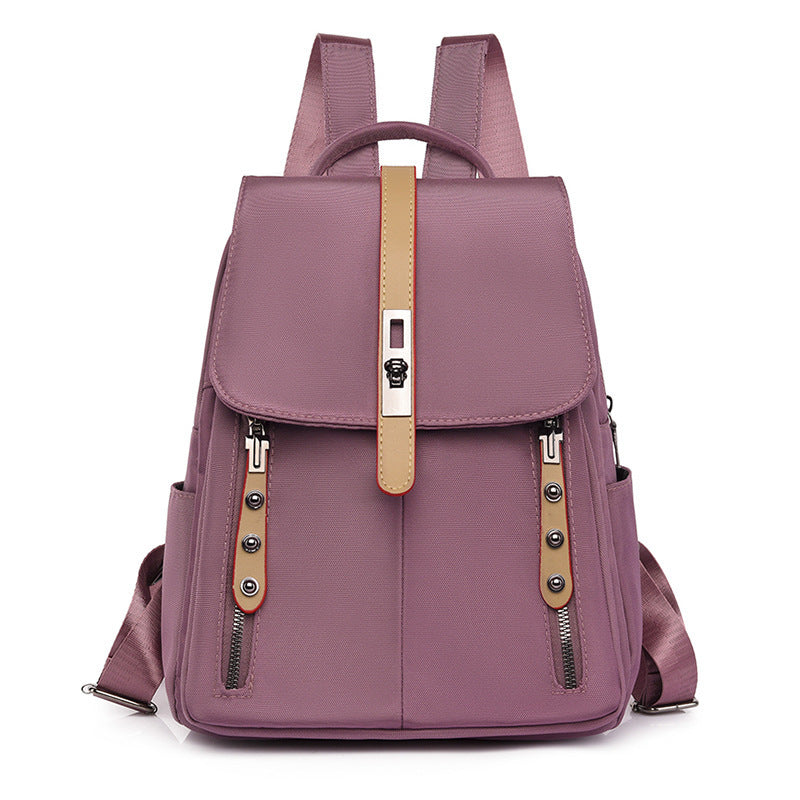 Anti-theft buckle backpack in dusty rose pink, with hidden back pocket and front lock, lightweight and compact for travel or daily use.