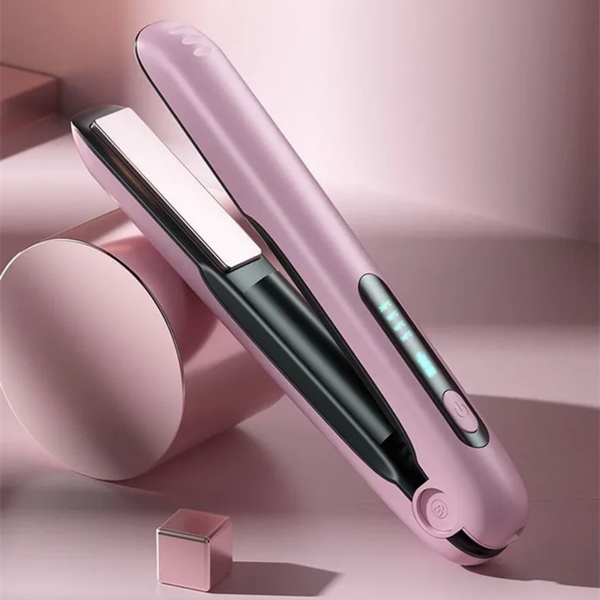 Pink wireless USB hair straightener on a pink background