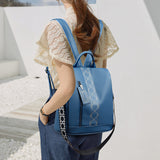 A woman wearing the Vegas anti-theft backpack in blue whilst traveling in the airport