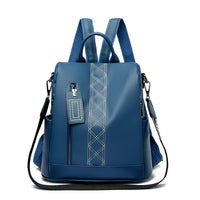 A cerulean blue anti-theft backpack with adjustable straps, zipper closures, and a card slot on the front. It has a sleek and elegant design.