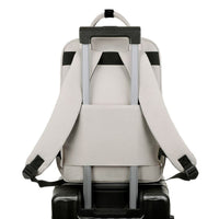 Backpack attached to a suitcase on a white background