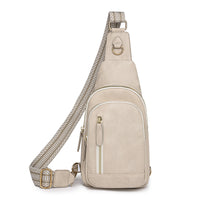 A beige chic retro cross body bag with a textured strap and multiple compartments.