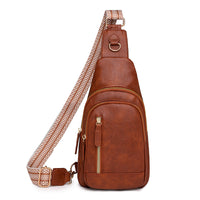 A brown retro cross body bag with a textured strap and multiple compartments.