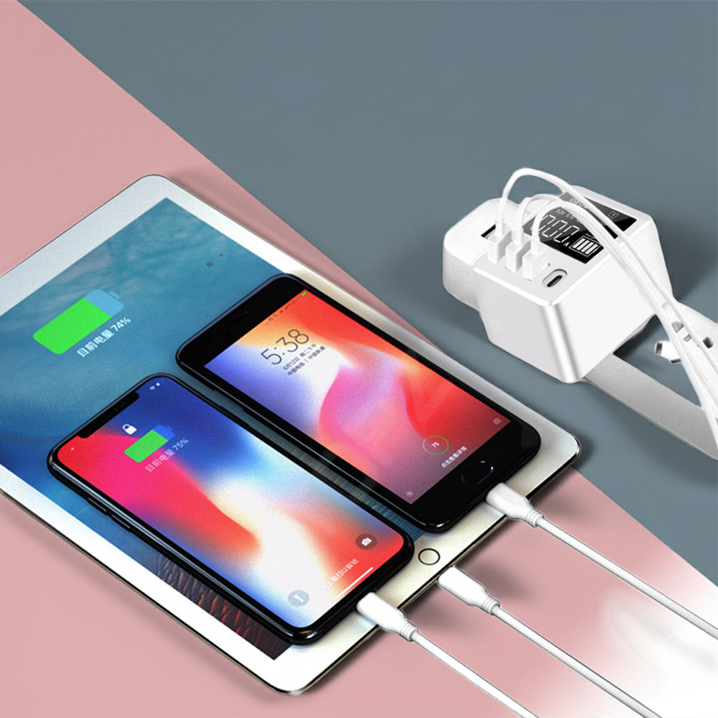 Multiple electronic devices, including smartphones and a tablet, connected to a charging station with multiple outlets.