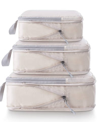 Set of three beige packing cubes with clear zipper sections on a white background