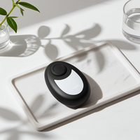 Crystal smooth skin hair remover with nano-glass surface in black, compact handheld hair removal tool with ergonomic finger ring, shown in a clean minimalist setting.