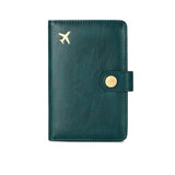 Turquoise blue green  leather travel passport valuables organizer with gold airplane emblem and button on a white background