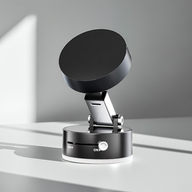 Foldable magnetic phone holder in black, combining vacuum suction and magnetic grip, compatible with most smartphones, shown mounted on dashboard for hands-free use.