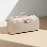 Beige cosmetic bag with star-shaped charms on a light background