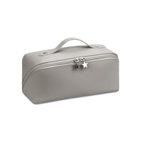 A cosmetics beauty travel organizer in a gray color with a zipper closure and a decorative star charm.