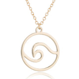 a golden wave pendant necklace on adjustable stainless steel chain, ocean-inspired jewelry.