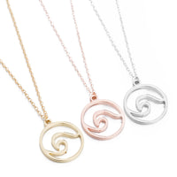 three wave pendant necklaces on adjustable stainless steel chains, ocean-inspired jewelry in three colors of gold, rose gold and silver.
