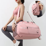 A woman holding a large capacity sports travel bag in pink color with multiple compartments, featuring a shoulder strap and the text 'SPORT' on the front.
