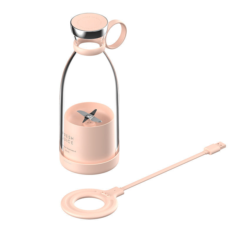 A portable smoothie maker with a pink base and a clear bottle attachment, along with a magnetic charging cable.