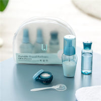 A set of refillable cosmetic containers in blue and clear colors, including various sizes with pump and spray nozzles, intended for travel use.