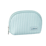 A hand holding a medium-sized beige cosmetic bag with a smooth metal zipper and a brand label reading 'Lush Faced'. The bag has a shell-like design and appears to be made of PU leather.