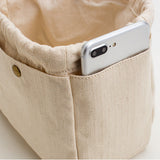 Details of the Beige cotton canvas bag organizer with multiple pockets, Japanese minimalist design, available in drawstring or zipper closure, shown in small/medium/large sizes.
