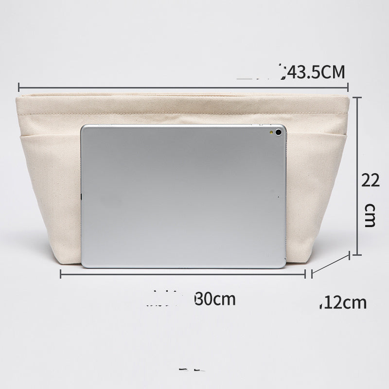 Details of the Beige cotton canvas bag organizer with multiple pockets, Japanese minimalist design, available in drawstring or zipper closure, shown in large next to a laptop for comparison