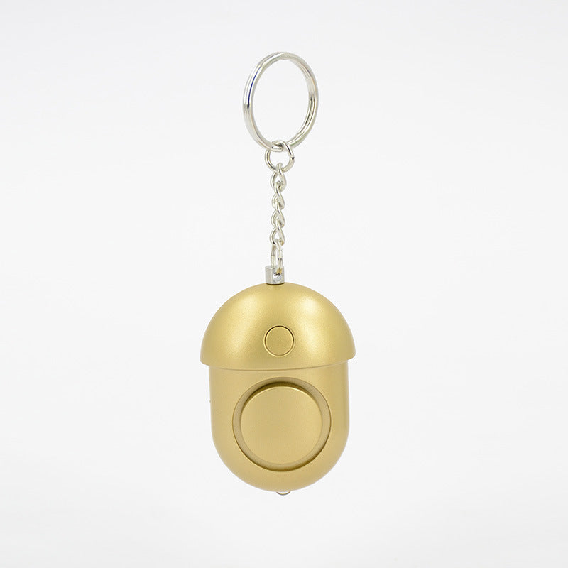 Compact 130dB personal alarm attached to keychain, travel-friendly safety device for women.