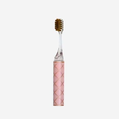 Pink toothbrush with a textured handle on a white background